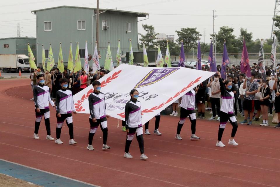 中華醫事科大五十四週年校慶運動會，師生迎接校旗進場。（記者黃文記攝）