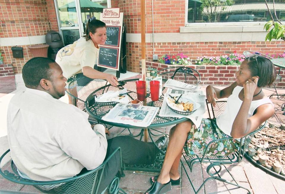 Marcus Stewart and Ericka M. Ellis-Stewart dine alfresco in August 2000 at Thomas Street Tavern. Bartender Tina Whitman pulls double duty and serves lunch to the Stewarts.