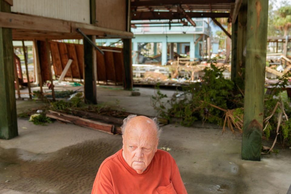Tom Lanier, 78, sits beneath his home, one of the few residents of Horseshoe Beach, Florida, who rode out the storm as he watched sheds, propane tanks, and other debris slammed into his home's structural beams during Hurricane Idalia, in Horseshoe Beach, Florida, U.S., August 30, 2023. 