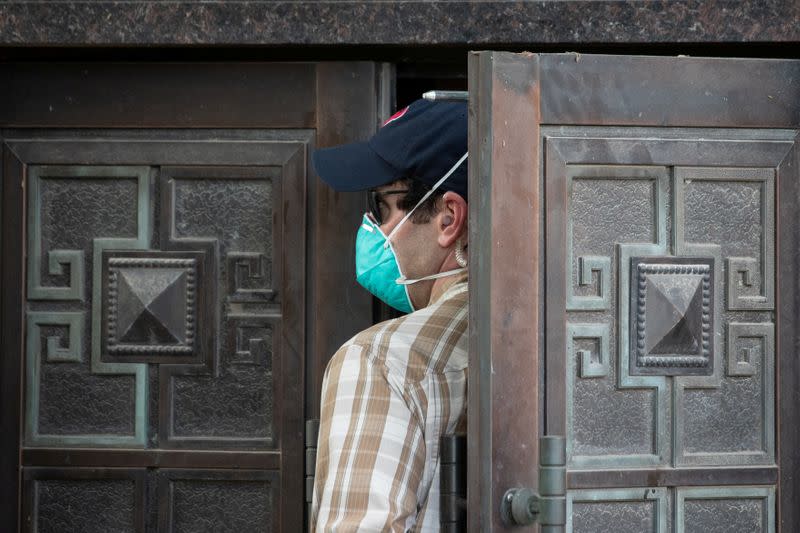 A plain clothes U.S. security official enters the back door of China’s Consulate after Chinese employees left the building, in Houston