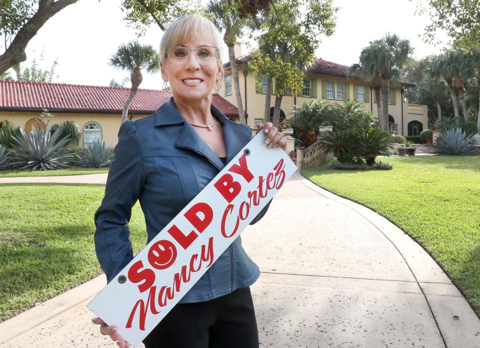 Nancy Cortez, an agent with Adams, Cameron & Co. Realtors, stands in front of a beachside luxury home she helped a local couple buy at 211 John Anderson Drive in Ormond Beach on Thursday, Nov. 30, 2023. The $2.7 million sale closed earlier in the month. Cortez said this year is the best she's had in the nearly 20 years she's been a Realtor.