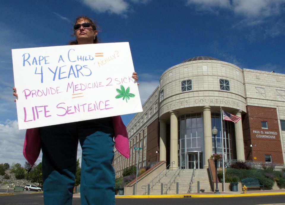 Medical marijuana patient Dawn Peterson-Smith protests Richard Flor's death Thursday Sept. 6, 2012, outside the federal courthouse in Helena, Mont., where Flor was sentenced on drug charges. Richard Flor was a medical marijuana provider who received a five-year sentence in a federal crackdown on large pot operations, but he died late last month while being transferred to a new jail. (AP Photo/Matt Volz)