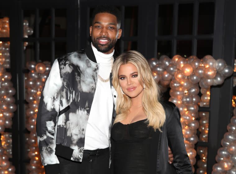 Tristan Thompson and Khloe Kardashian pose for a photo at a glitzy party