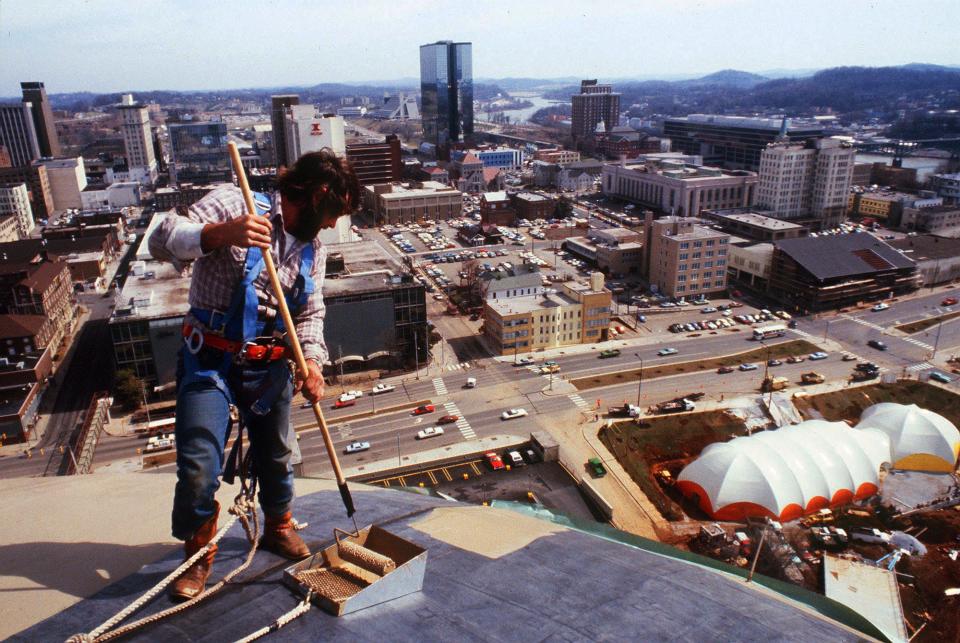 A.C. Cusick with Capitol Roofing Co. keeps his mind on his job and his secure footing as he paints the top of the Sunsphere, 266 feet above the site of the 1982 World's Fair. The rubber roof of the sphere got two coats of gold paint to match the gold glass in the sphere.