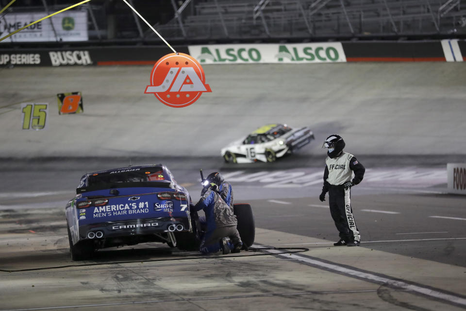 An official watches as a pit crew works on the car belonging to Justin Allgaier during NASCAR Xfinity Series auto race at Bristol Motor Speedway Monday, June 1, 2020, in Bristol, Tenn. (AP Photo/Mark Humphrey)