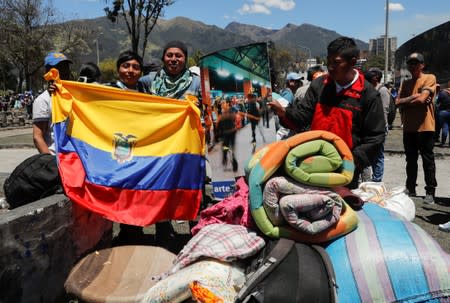 People clean debris from the streets in the aftermath of the last days' protests in Quito