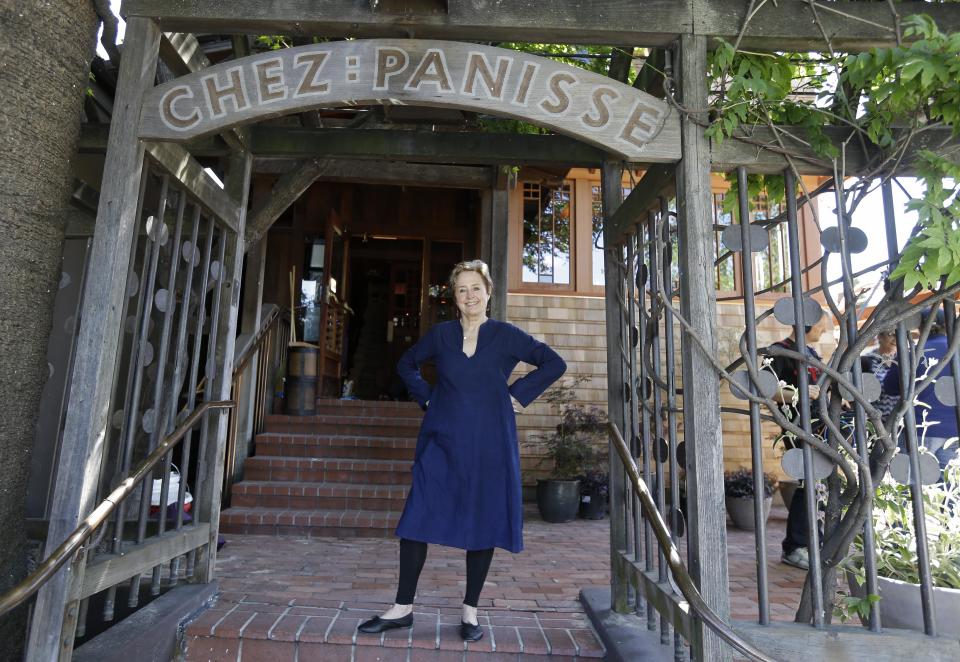 In this photo taken Thursday, June 20, 2013 Alice Waters poses outside the new front entrance to Chez Panisse restaurant in Berkeley, Calif. After a fire in March shut the doors to the famous gourmet restaurant, the eatery is preparing to reopen on Monday, June 24. (AP Photo/Eric Risberg)