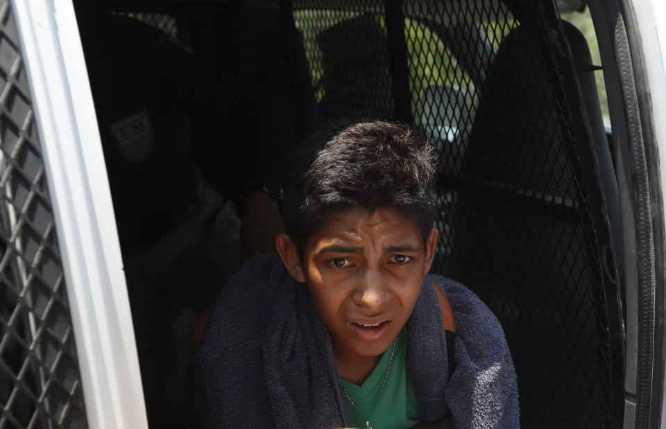 A Central American migrant detained by Mexican immigration agents looks out from a van on the highway to Pijijiapan, Mexico, Monday, April 22, 2019. Mexican police and immigration agents detained hundreds of Central American migrants on Monday, the largest single raid on a migrant caravan since the groups started moving through Mexico last year. (AP Photo/Moises Castillo)