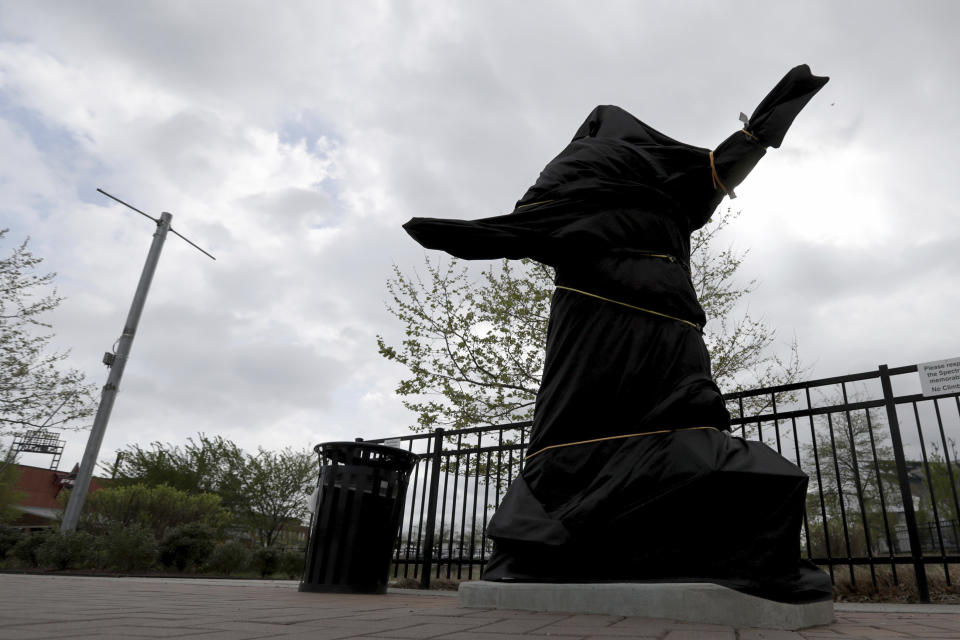 The covered Kate Smith statue sits outside Wells Fargo Center in Philadelphia on Friday, April 19, 2019. The Philadelphia Flyers covered the statue of singer Kate Smith outside their arena, following the New York Yankees in cutting ties and looking into allegations of racism against the 1930s star with a popular recording of “God Bless America.” Flyers officials said Friday they also plan to remove Smith’s recording of “God Bless America” from their library. They say several songs performed by Smith “contain offensive lyrics that do not reflect our values as an organization.” (David Maialetti/The Philadelphia Inquirer via AP)
