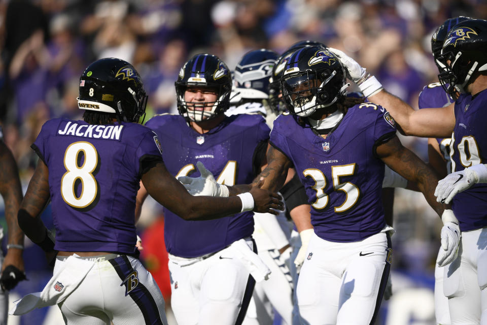 Baltimore Ravens running back Gus Edwards (35) celebrates with teammate quarterback Lamar Jackson (8) after a 3-yard touchdown run during the first half of an NFL football game against the Seattle Seahawks, Sunday, Nov. 5, 2023, in Baltimore. (AP Photo/Nick Wass)