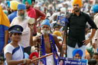 A supporter of Bahujan Samaj Party (BSP) plays a plays a damru, a small two headed drum, during an election campaign rally addressed by the party's chief Mayawati on the occasion of the death anniversary of Kanshi Ram, founder of BSP, in Lucknow, India, October 9, 2016. REUTERS/Pawan Kumar