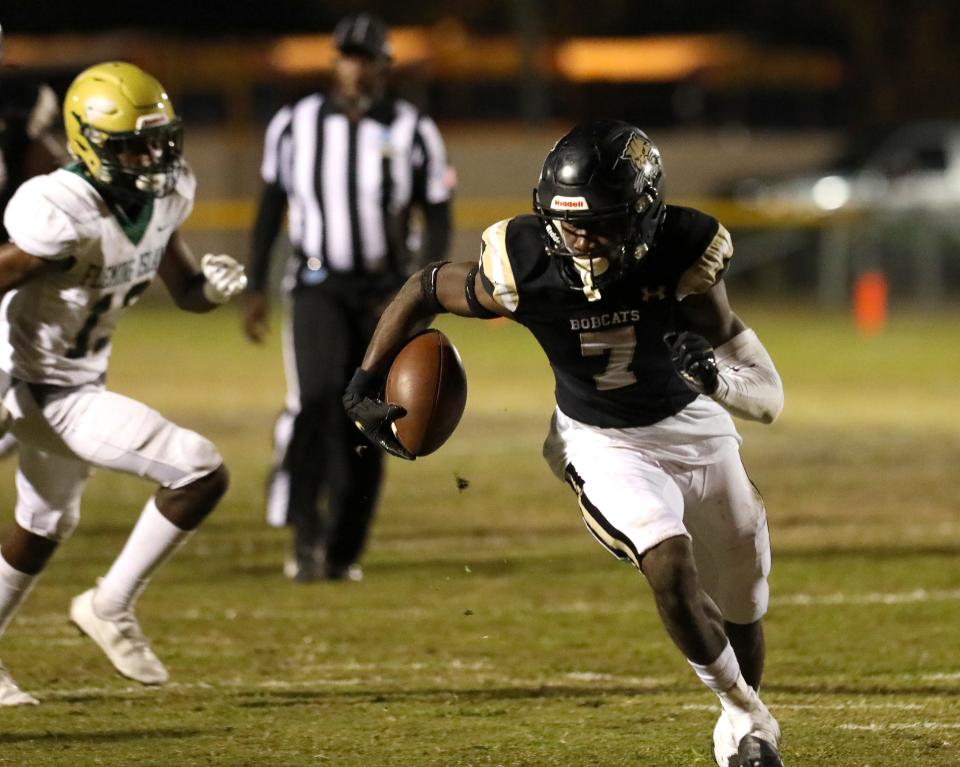 Buchholz High School wide receiver Quan Lee (7) turns the ball upfield after making a catch as the Bobcats play Fleming Island High School during the opening round of the 6A state football playoffs, held at Citizens Field in Gainesville Nov. 11, 2021. Buchholz won 35-7 to advance in the playoffs.