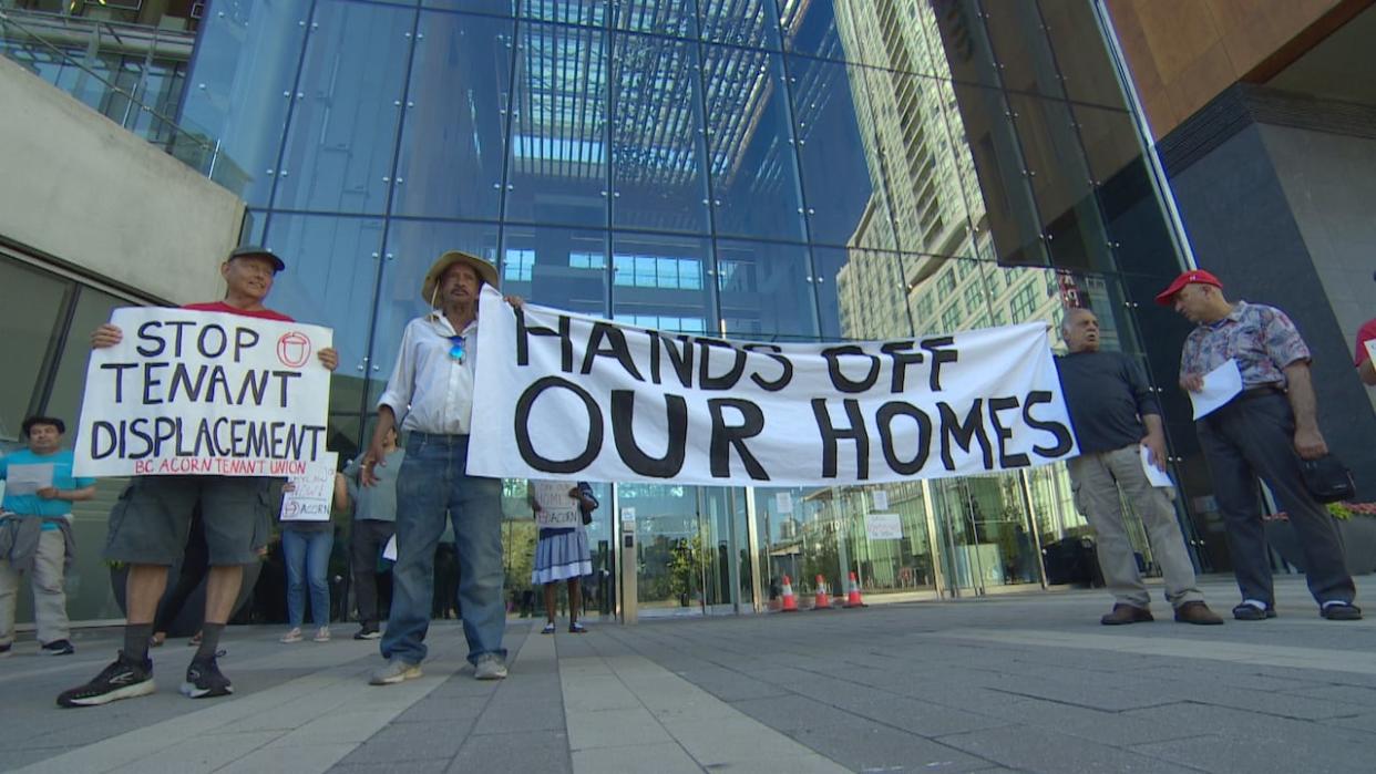 Housing advocacy union ACORN joined Elizabeth Manor residents and neighbours outside Surrey City Hall on Monday evening to protest the planned redevelopment.  (CBC News - image credit)