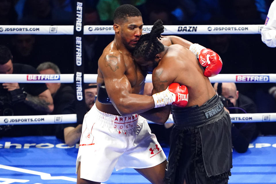 Former unified heavyweight champion Anthony Joshua (left) holds Jermaine Franklin during his unanimous decision win Saturday in London. (Zac Goodwin/Getty Images)
