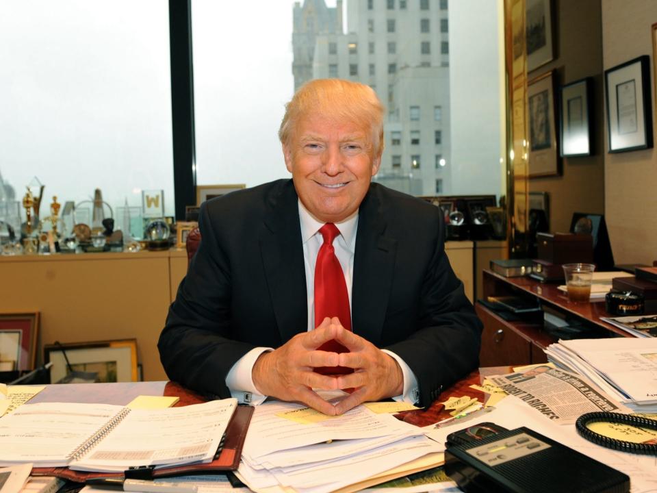 donald trump tower sitting desk smiling smile