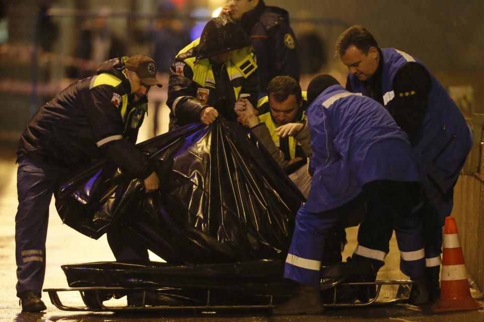 Medics lift the body of Boris Nemtsov who was shot dead in central Moscow