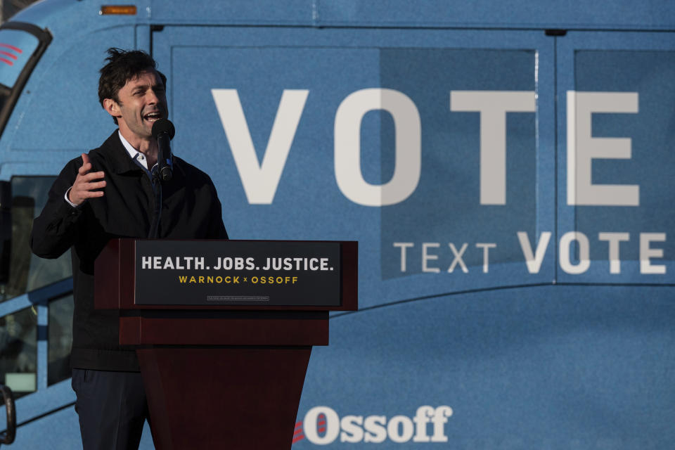 Democratic Georgia Senate challenger Jon Ossoff addresses supporters during a rally with the Rev. Rafael Warnock in Atlanta on the first day of early voting for the senate runoff Monday, Dec. 14, 2020. (AP Photo/Ben Gray)