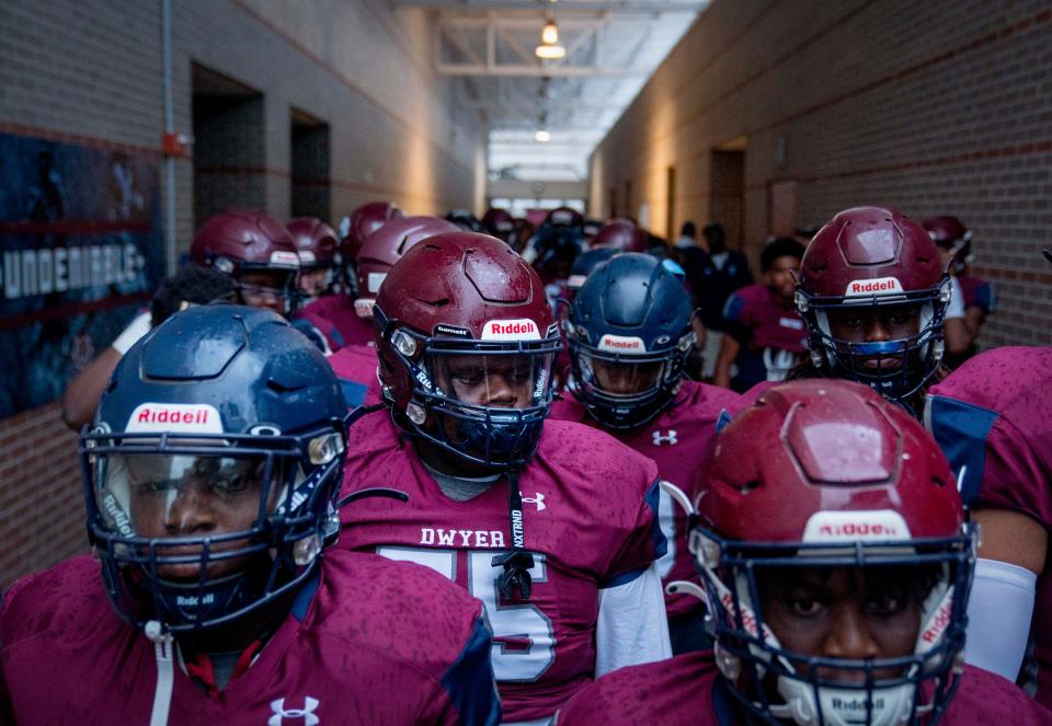 Dwyer football players get ready to take the field against Pahokee in Palm Beach Gardens, Florida on September 29, 2023.