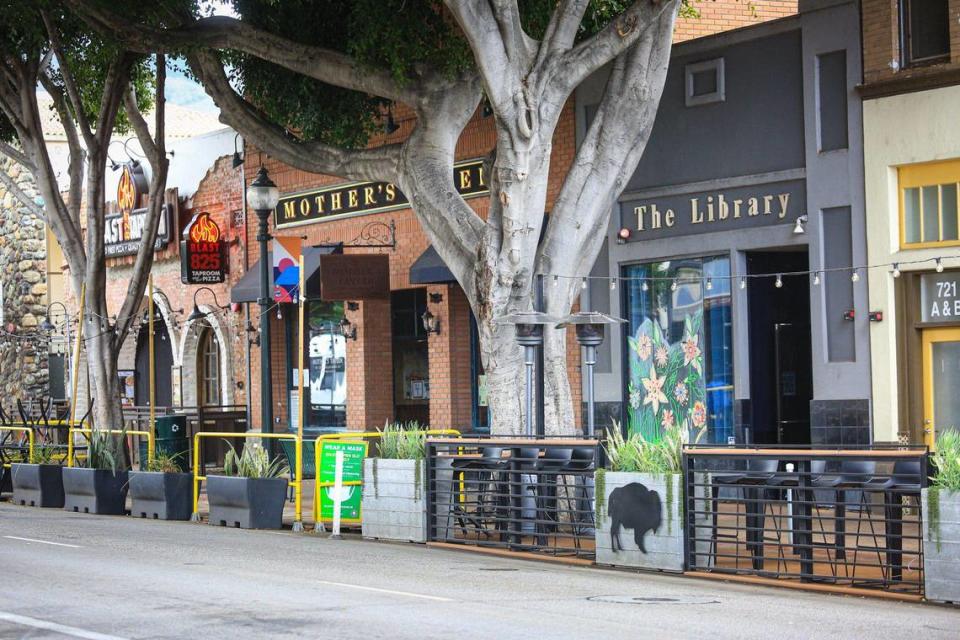 This view is near Mother’s Tavern and The Library bars.Higuera Street in downtown San Luis Obispo has been reduced from three lanes to two as pocket dining areas have been installed in former parking and driving lanes. March 10, 2021.