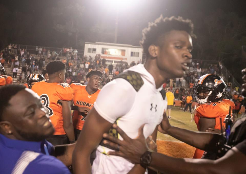 Pahokee players are held back during a scuffle after they lost on  Friday, Nov. 25, 2022, at Hawthorne High School in Hawthorne, Fla. during the 2022 FHSAA Football State Championships play off.  Hawthorne held on to win 21-20.  [Alan Youngblood/Gainesville Sun]