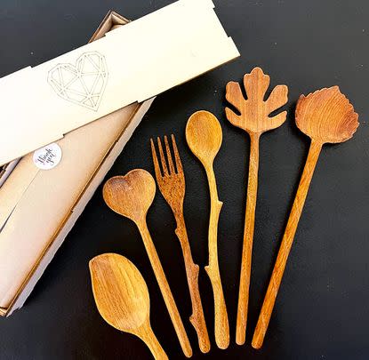 A set of natural wood serving spoons designed to look like different leaves