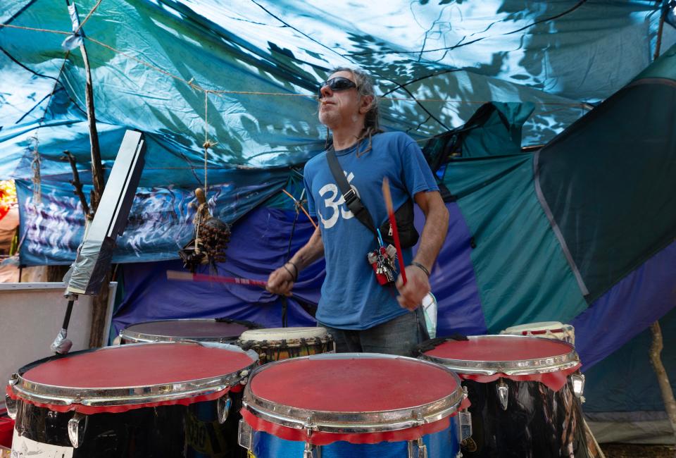 John Eustor, who calls himself a practicing shaman, plays the drums at the Neptune homeless encampment where he lives. 4/19/23