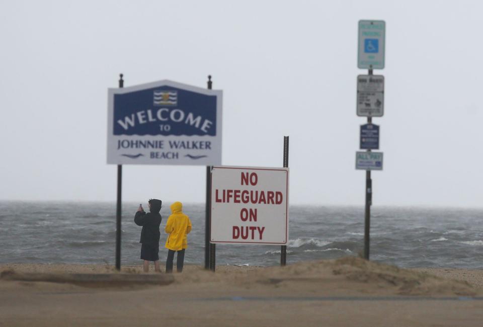 People visit Johnnie Walker beach in Lewes on the Delaware Bay to gauge the effects of tropical storm Ophelia Saturday afternoon, Sept. 23, 2023.