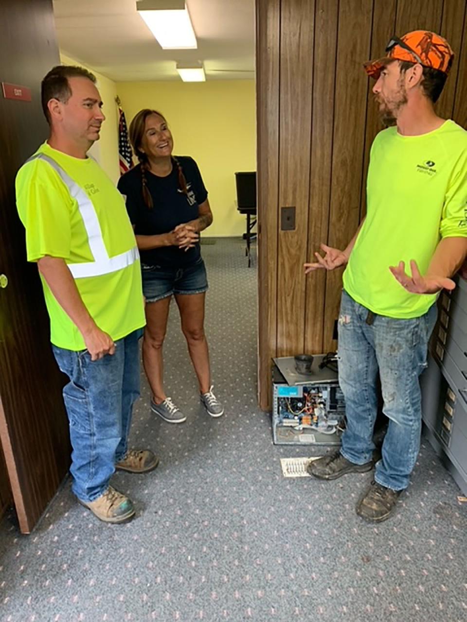 Colon DPW workers Matt Barrett and John Walls are given instructions from village office manager Billi Farrand regarding items to move Tuesday. The village relocated to a new site a block away.