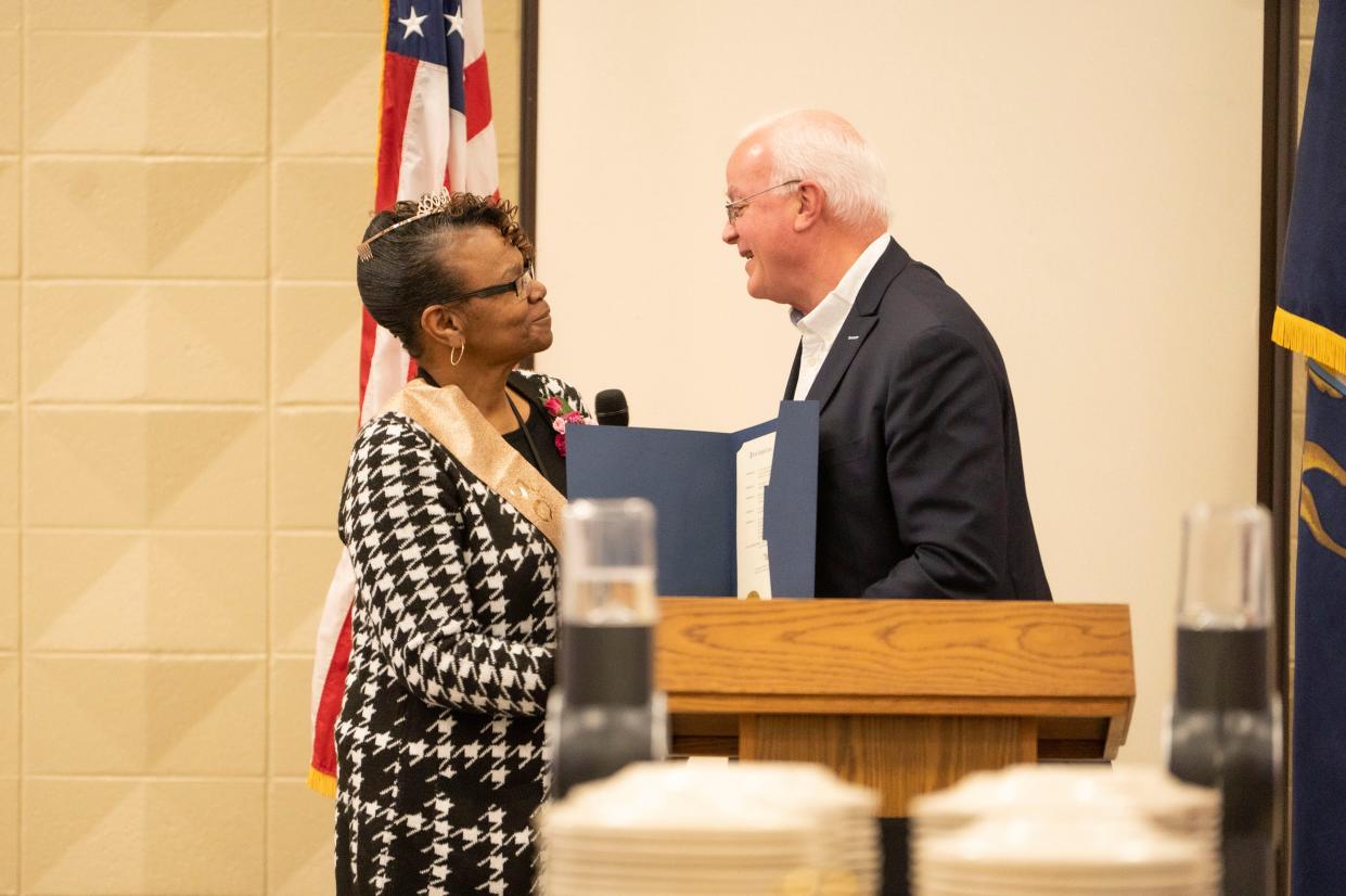 Battle Creek Mayor Mark Behnke reads a proclamation commemorating Ida McCray's 50th year teaching during a celebration at Calhoun Area Career Center on Wednesday, Jan. 18, 2023.