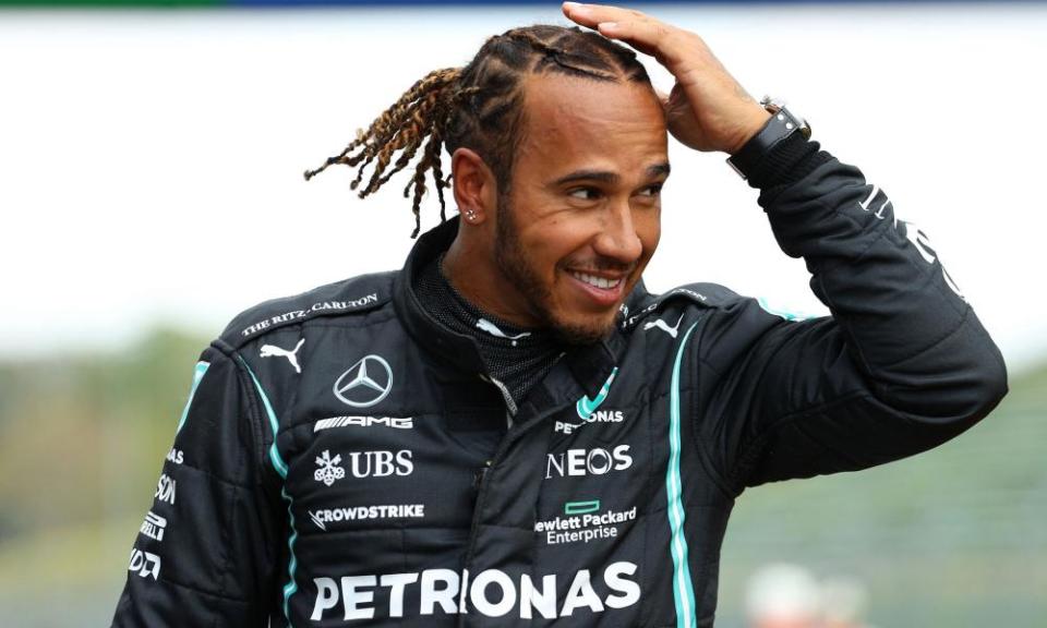 Lewis Hamilton celebrates after taking the 99th pole of his career