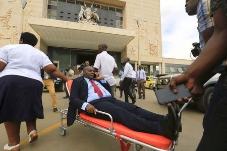 A sick opposition Ugandan lawmaker is wheeled on a stretcher to attend the debate in parliament to change the constitution to extend the president's rule, in Kampala, Uganda September 21, 2017. REUTERS/James Akena