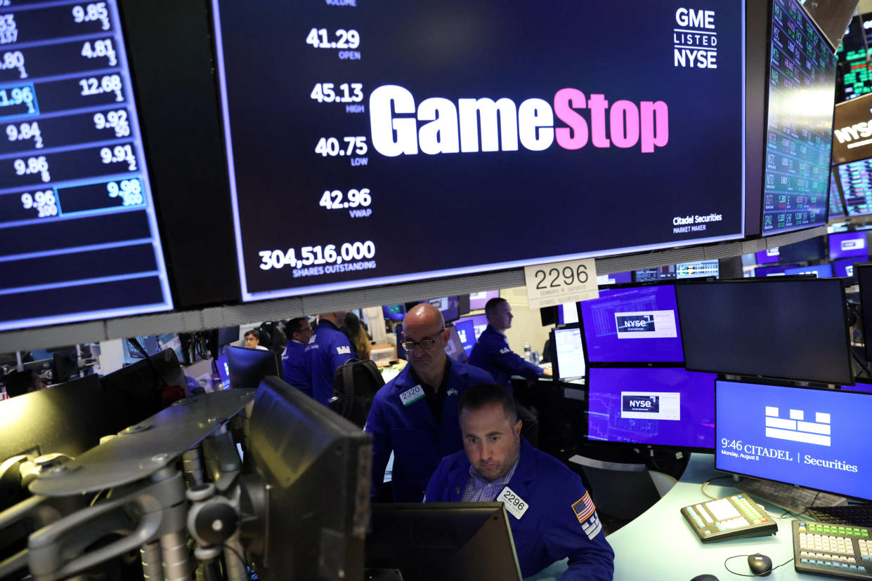 Traders work under signage for GameStop Corp. (NYSE: GME) on the trading floor at the New York Stock Exchange (NYSE) in Manhattan, New York City, U.S., August 8, 2022. REUTERS/Andrew Kelly