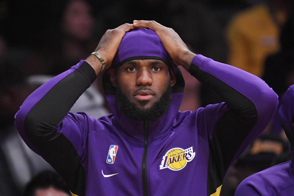 Los Angeles Lakers forward LeBron James sits on the bench during the first half of a preseason NBA basketball game against the Golden State Warriors, Monday, Oct. 14, 2019, in Los Angeles. (AP Photo/Mark J. Terrill)