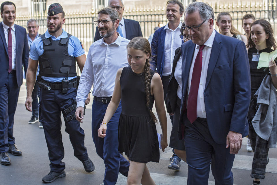 Swedish climate activist Greta Thunberg, centre, arrives for a meeting in the French National Assembly, in Paris, France, Tuesdays, July 23, 2019. (AP Photo/Rafael Yaghobzadeh )