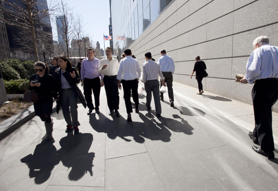 FILE- In this March 14, 2012, file photo people come and go from Goldman Sachs headquarters in New York. Business casual has become such an entrenched trend that even Goldman Sachs surrendered to it with a memo to employees announcing flexible dress code. Goldman Sachs first relaxed its dress code for its technology and digital division employees in 2017. Expanding the policy to the rest of its workforce, Goldman cited its “one firm philosophy and the changing nature of workplaces.” The change comes three years after the country’s largest bank, JPMorgan Chase & Co, adopted its own firmwide flexible dress policy. (AP Photo/Mark Lennihan, File)