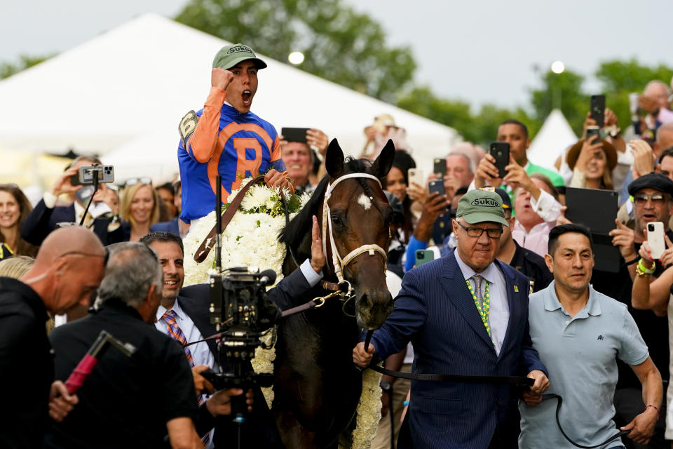 Jockey Irad Ortiz Jr. clenches his fist as Mo Donegal (6) is led after winning the 154th running of the Belmont Stakes horse race, Saturday, June 11, 2022, at Belmont Park in Elmont, N.Y. (AP Photo/Frank Franklin II)