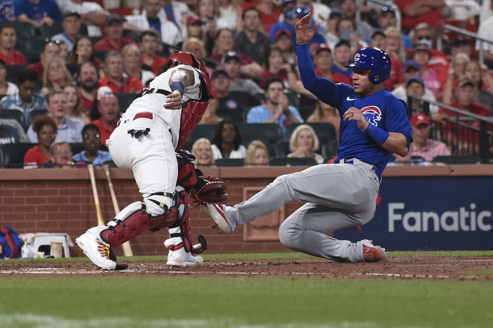 St. Louis Cardinals catcher Yadier Molina, left, tags out Chicago Cubs' Willson Contreras during the sixth inning of a baseball game Wednesday, July 21, 2021, in St. Louis. (AP Photo/Joe Puetz)