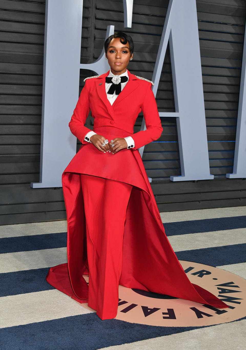 <p>Janelle Monáe is famed for her love of capes on the red carpet and for the <em>Vanity Fair</em> Oscar after-party, the actress wore a slick red co-ord by Christian Siriano. The bejewelled bow, sweeping cape and slick shirt all caught our attention and for that, it’s one of the most memorable ensembles of 2018. <em>[Photo: Getty]</em> </p>