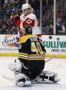 Boston Bruins goalie Tuukka Rask makes a save as Detroit Red Wings' David Legwand screens during the first period of Game 1 of a first-round NHL playoff hockey series in Boston on Friday, April 18, 2014. (AP Photo/Winslow Townson)