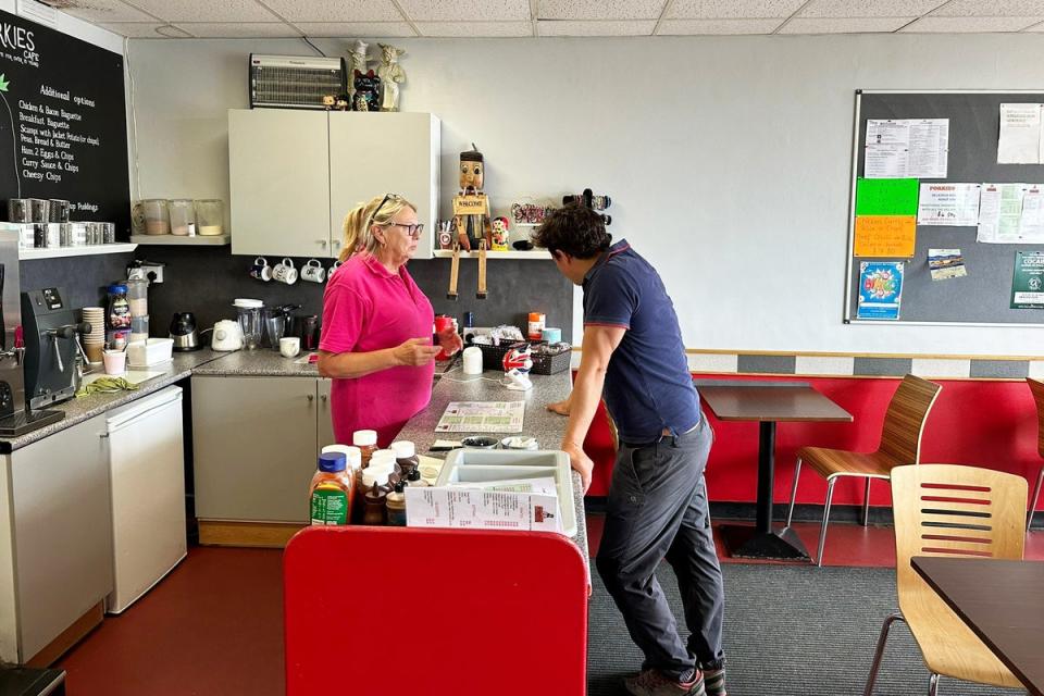 Johnny Mercer talks to Sharon Cross, manager of Porkies Cafe, before sitting down for a cheese and ham sandwich (The Independent)