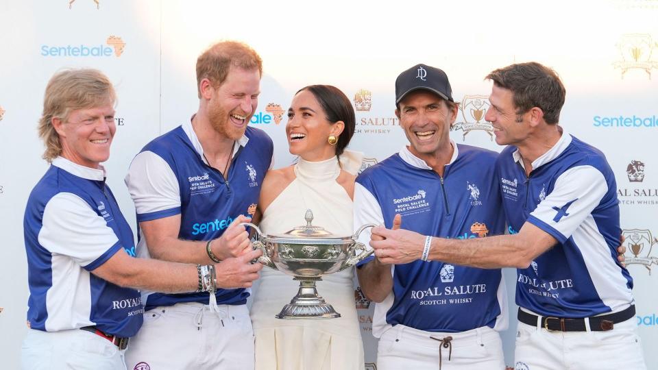 The couple laugh together as Meghan presents him and his polo teammates with the trophy for winning the 2024 Royal Salute Polo Challenge to Benefit Sentebale