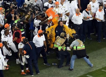 Feb 7, 2016; Santa Clara, CA, USA; Denver Broncos head coach Gary Kubiak is doused by gatorade by linebacker DeMarcus Ware (94) and Von Miller (58) after defeating the the Carolina Panthers 24-10 in Super Bowl 50 at Levi's Stadium. Mandatory Credit: USA TODAY Sports