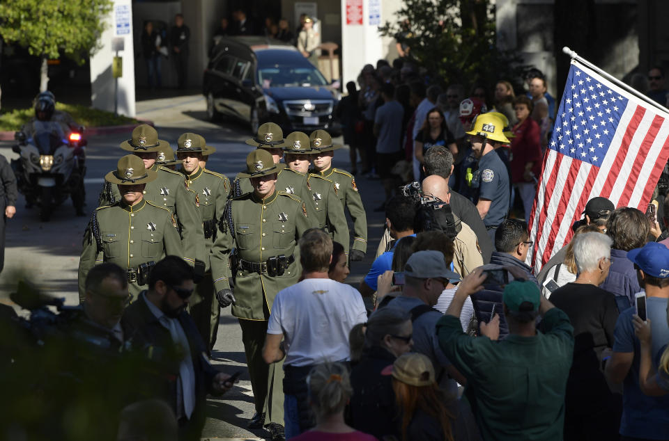 The body of Ventura County Sheriff's Department Sgt. Ron Helus is transported from the Los Robles Regional Medical Center Thursday, Nov. 8, 2018, in Thousand Oaks, Calif., after a gunman opened fire Wednesday inside a country music bar killing multiple people including Helus. (AP Photo/Mark J. Terrill)