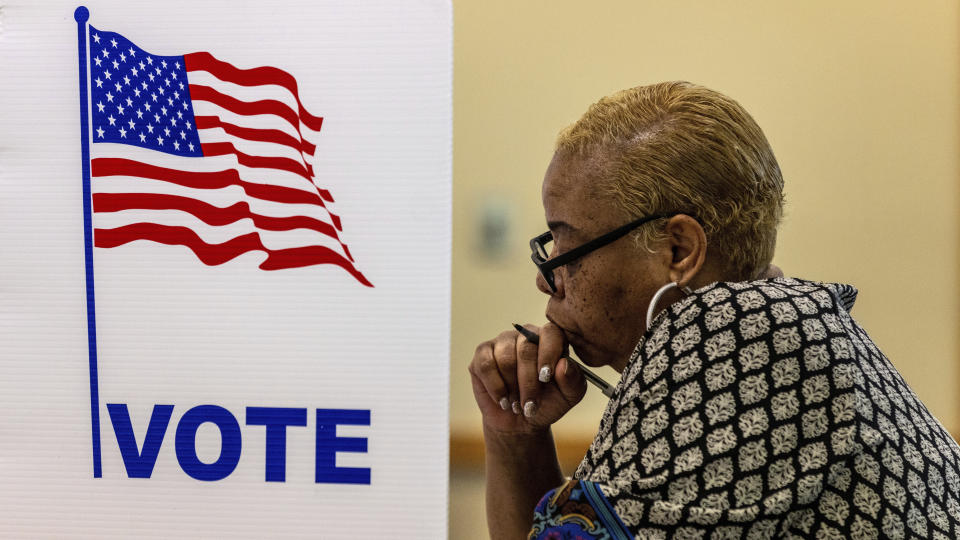 FILE - Larnisha Dortch fills out her ballot at Fontenelle Forest during Nebraska's primary election on Tuesday, May 10, 2022, in Bellevue, Neb. Voters across the country are deciding ballot measures that could reshape the ways they cast ballots in coming elections. (Chris Machian/Omaha World-Herald via AP, File)