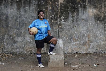 Rachel Blaekly, an 18-year-old student, poses during a football practice session at a playground in Mumbai March 24, 2014. REUTERS/Danish Siddiqui