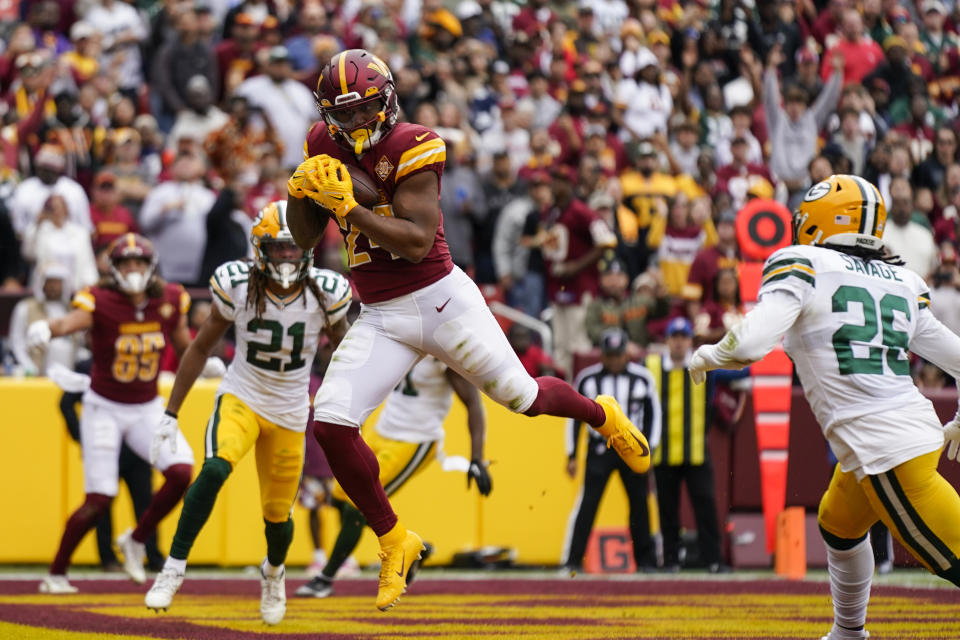 Washington Commanders running back Antonio Gibson catches a touchdown pass in front of Green Bay Packers safety Darnell Savage (26) during the first half of an NFL football game Sunday, Oct. 23, 2022, in Landover, Md. (AP Photo/Patrick Semansky)