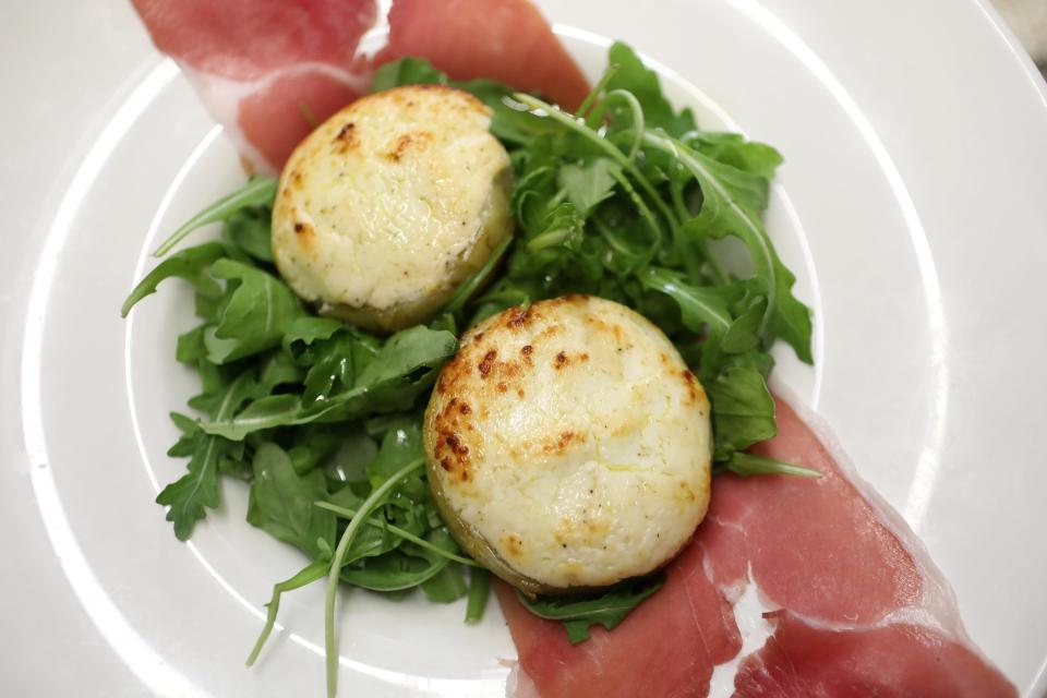 A dish of stuffed artichoke hearts and prosciutto sit on a table at Trattoria San Pietro in Norwell.