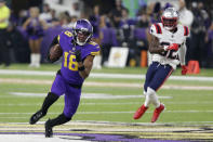 Minnesota Vikings wide receiver Justin Jefferson (18) runs from New England Patriots safety Devin McCourty (32) after catching a pass during the first half of an NFL football game, Thursday, Nov. 24, 2022, in Minneapolis. (AP Photo/Andy Clayton-King)