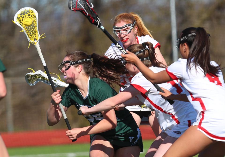 YorktownÕs Ava Cunneen (25) breaks away from a host of Somers defenders as she drives to the goal during girls lacrosse action at Somers High School April 25, 2024. Yorktown won the game 8-5.