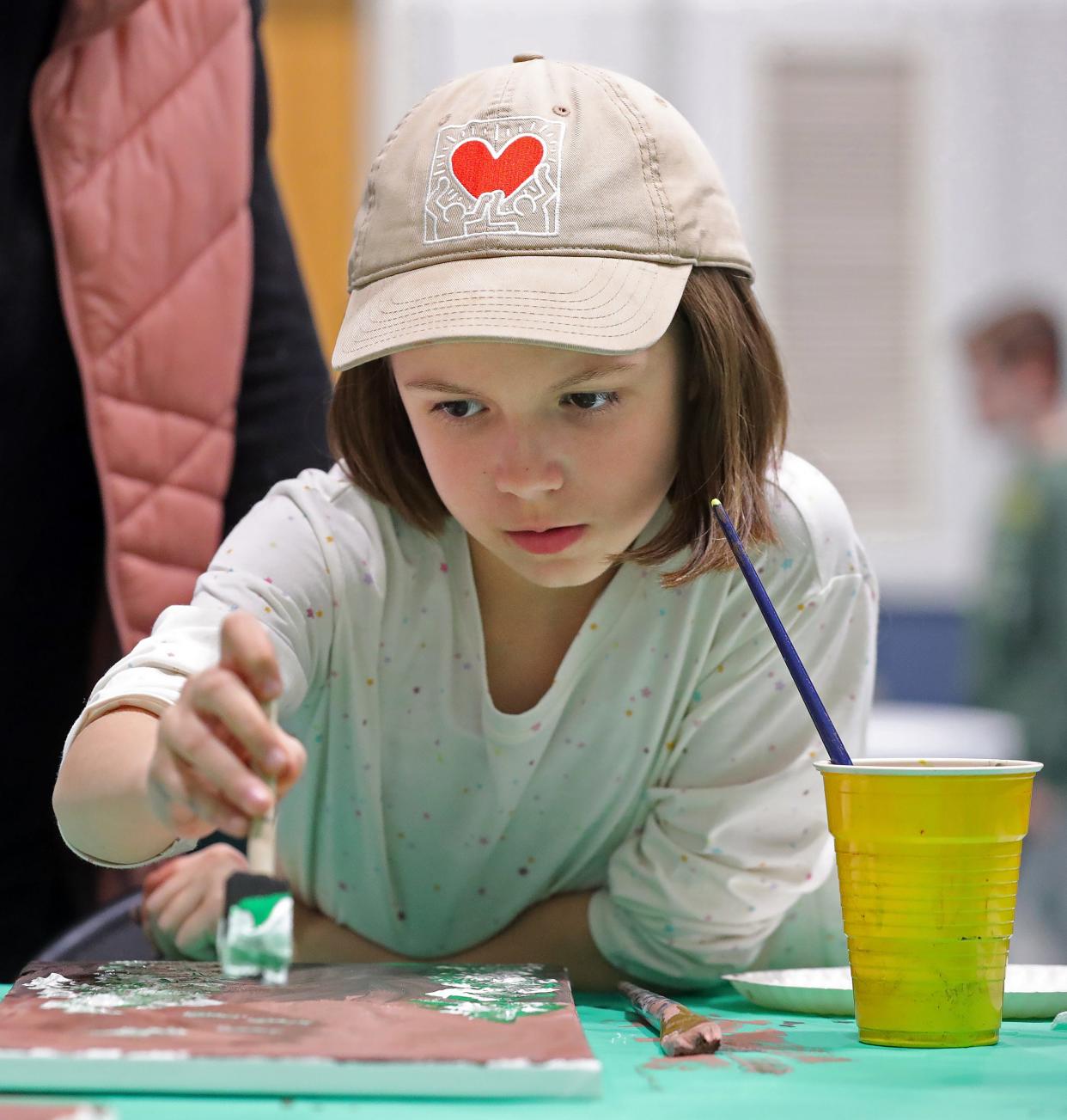 Charlie Foreit of Brunswick, 9, paints snowflakes during an Integrated Community Solutions art class at Medina County Board of Developmental Disabilities in Medina.